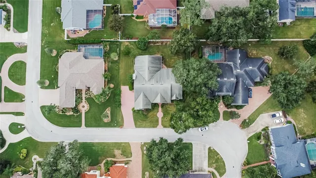 an aerial view of a house with outdoor space and lake view