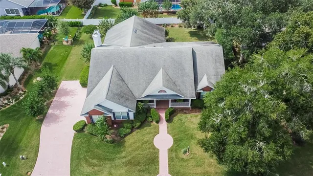 an aerial view of a house with swimming pool and garden