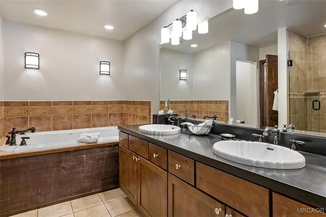 a bathroom with double sink and a mirror