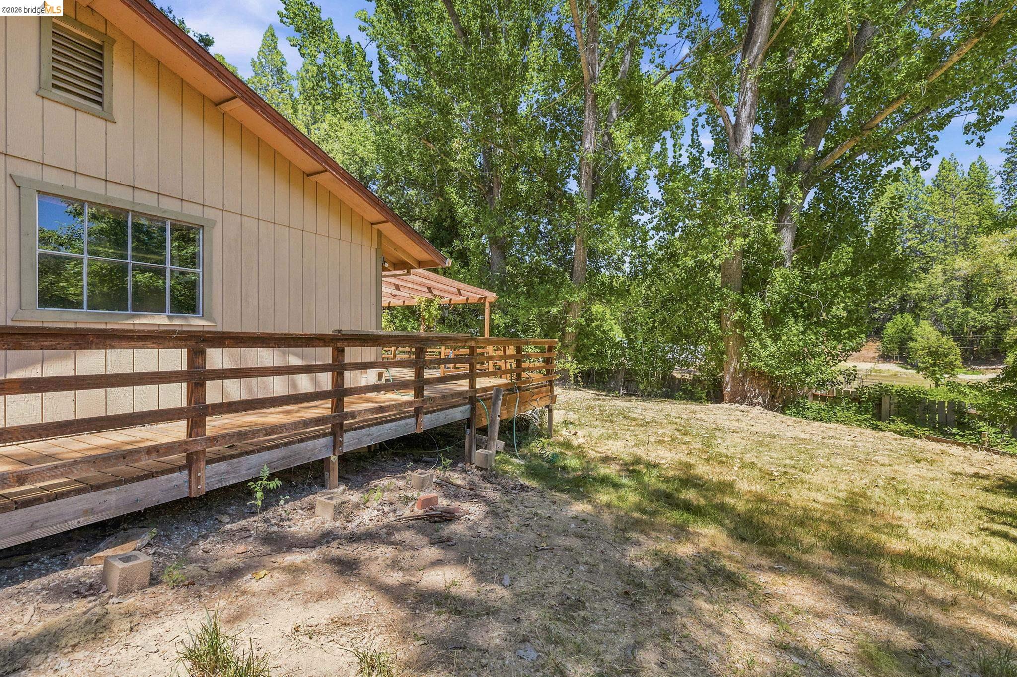 22401 South Fork Road Sonora, CA 95370 - Photo 3 of 34 Exterior featuring a wooden deck with railing, horizontal siding, and a gabled roof