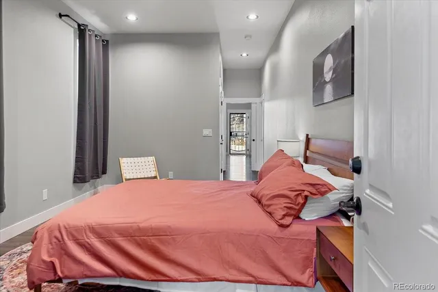 a bedroom with a bed and a painting on the wall