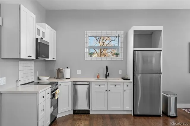 a kitchen with a sink cabinets and stainless steel appliances