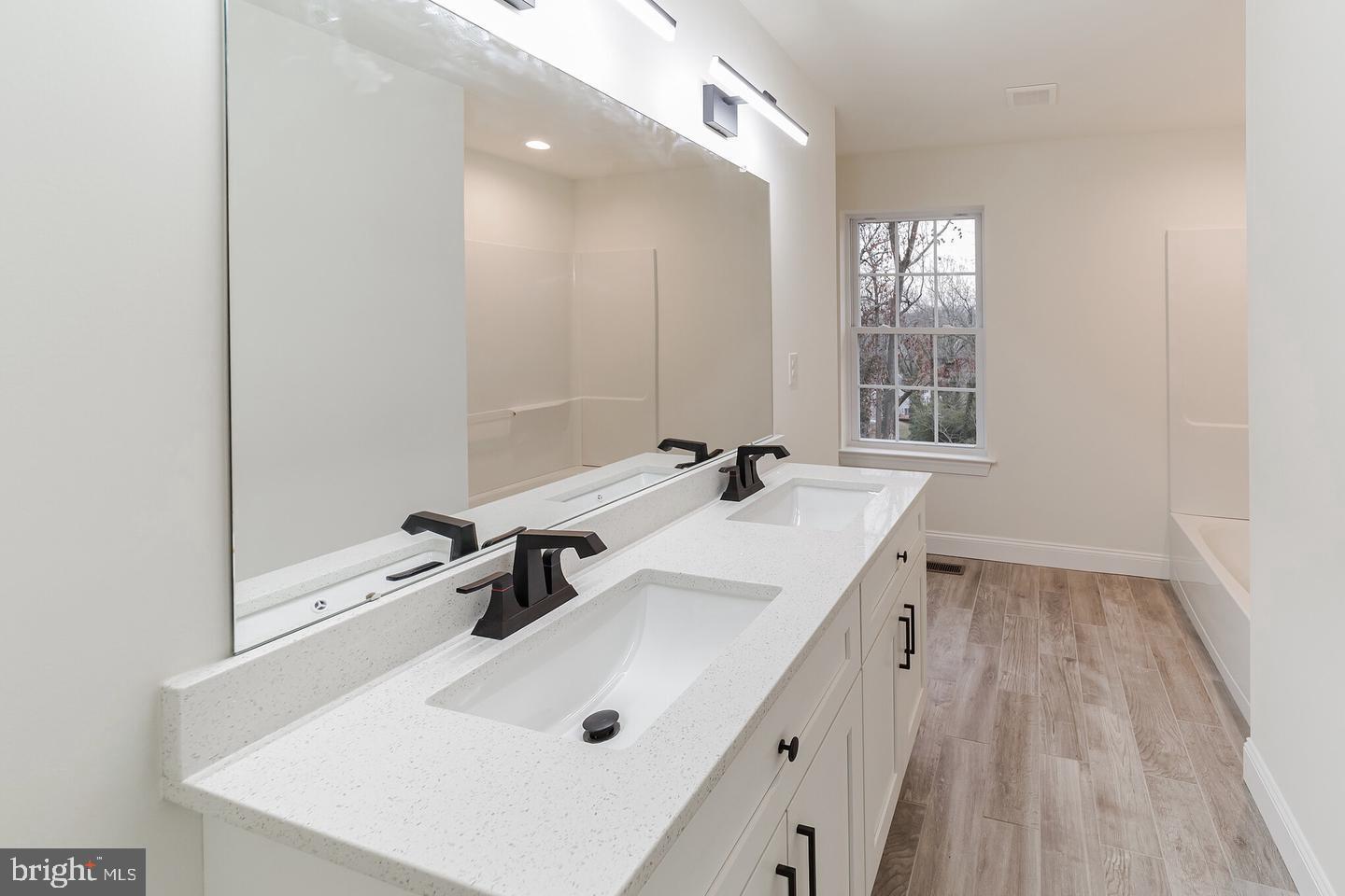 274 Oak Avenue Media, PA 19063 - Photo 23 of 27 a bathroom with a sink a mirror and a bathtub