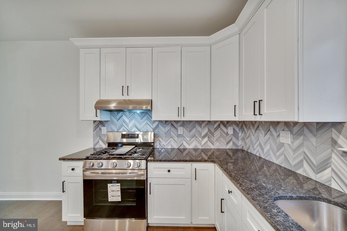 274 Oak Avenue Media, PA 19063 - Photo 6 of 27 a kitchen with granite countertop a stove sink and cabinets