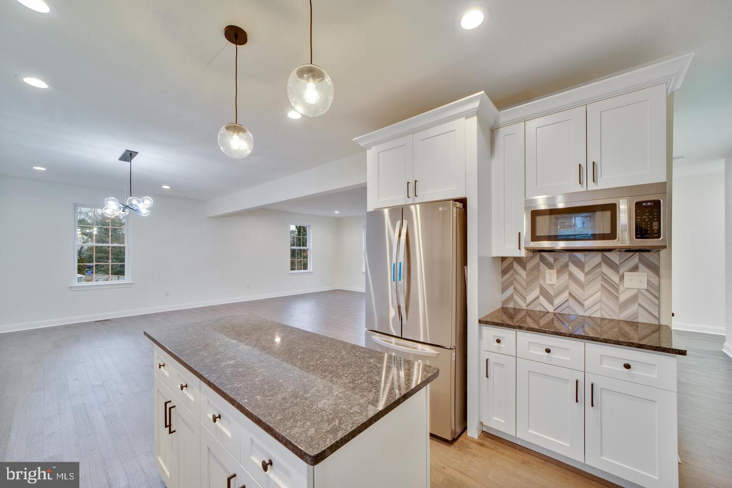 274 Oak Avenue Media, PA 19063 - Photo 7 of 27 a kitchen with stainless steel appliances granite countertop a refrigerator a oven and white cabinets with wooden floors