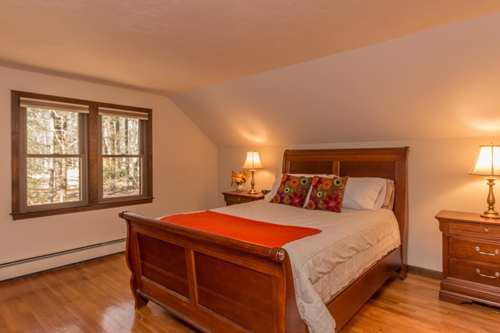 23 Country Road Lunenburg, MA 01462 - Photo 13 of 21 a bedroom with a bed and wooden floor