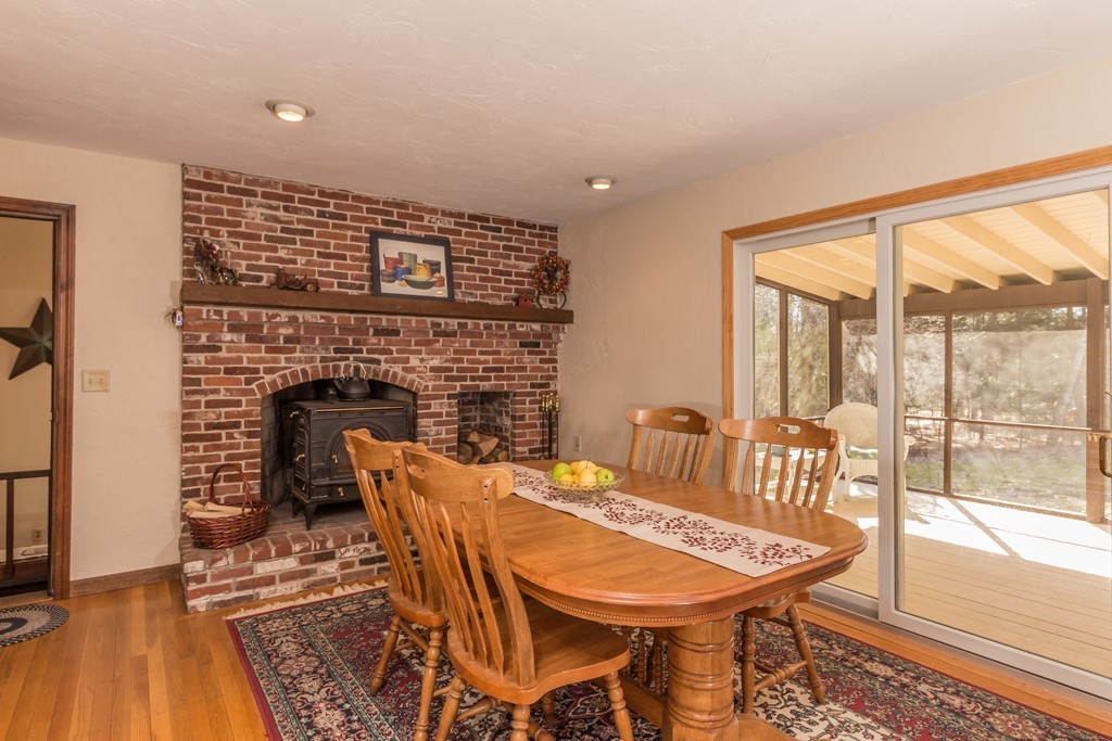 23 Country Road Lunenburg, MA 01462 - Photo 3 of 21 a dining room with furniture a fireplace and wooden floor