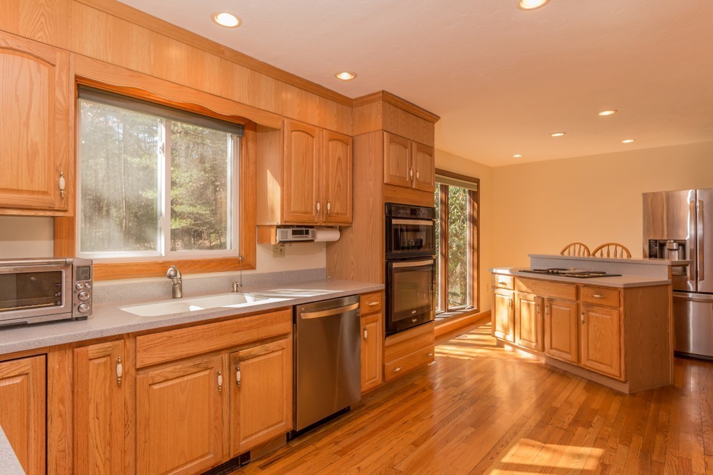 23 Country Road Lunenburg, MA 01462 - Photo 5 of 21 a kitchen with stainless steel appliances granite countertop a sink stove and refrigerator