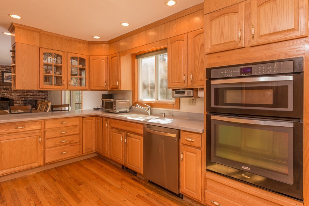 23 Country Road Lunenburg, MA 01462 - Photo 6 of 21 a kitchen with stainless steel appliances granite countertop a stove a sink and a microwave