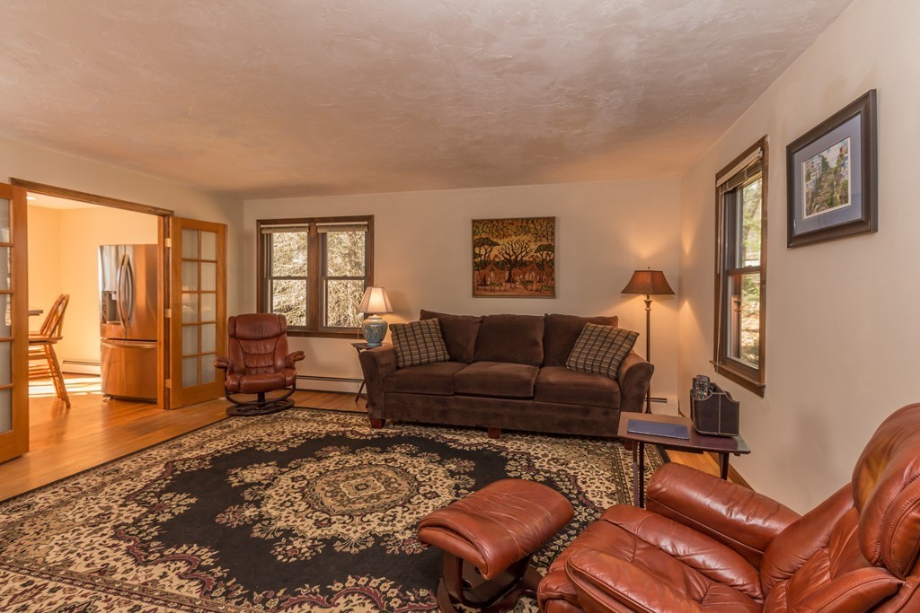 23 Country Road Lunenburg, MA 01462 - Photo 8 of 21 a living room with furniture or couch and a floor to ceiling window