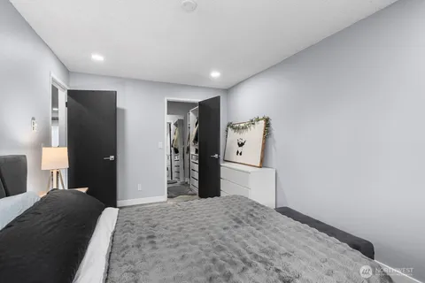 a bedroom with a bed and a television