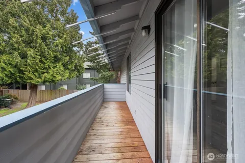 a view of balcony with wooden floor