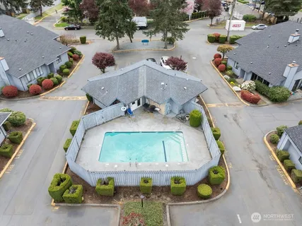 an aerial view of a house with a swimming pool