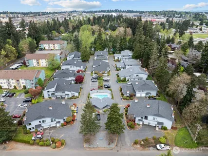 an aerial view of a house with table and chairs