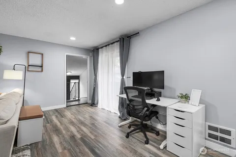 a view of a workspace with furniture and a window