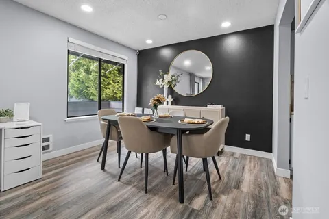 a view of a dining room with a table and chairs