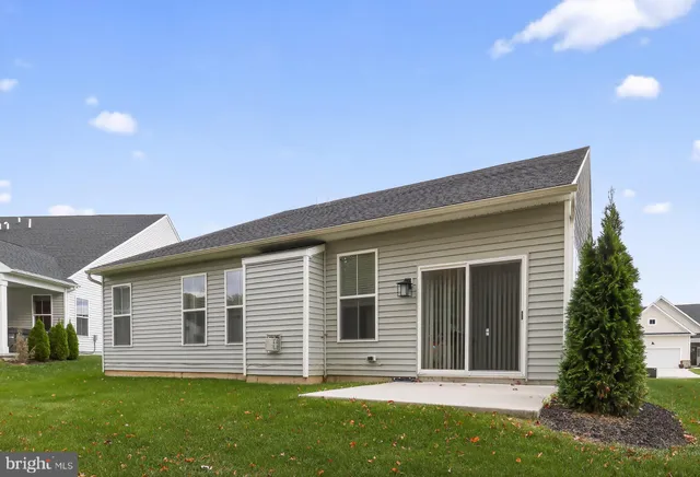 a front view of house with a garden