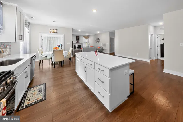 a large white kitchen with sink and dishwasher stove