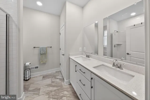 a spacious bathroom with a double vanity sink mirror double and shower