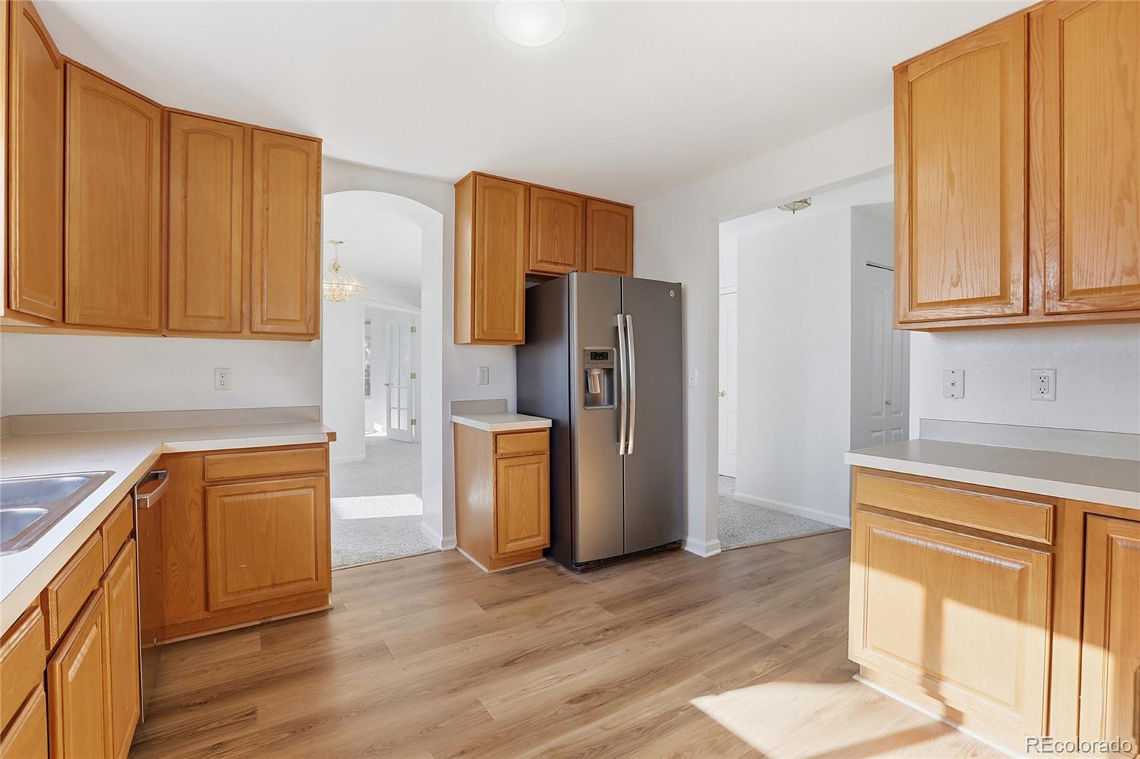 3736 South Inca Street Englewood, CO 80110 - Photo 11 of 31 a kitchen with stainless steel appliances granite countertop a refrigerator and a stove top oven