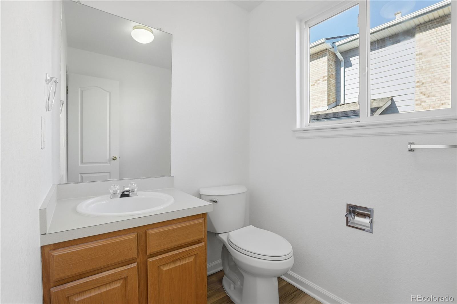3736 South Inca Street Englewood, CO 80110 - Photo 13 of 31 a bathroom with a sink a toilet and a window