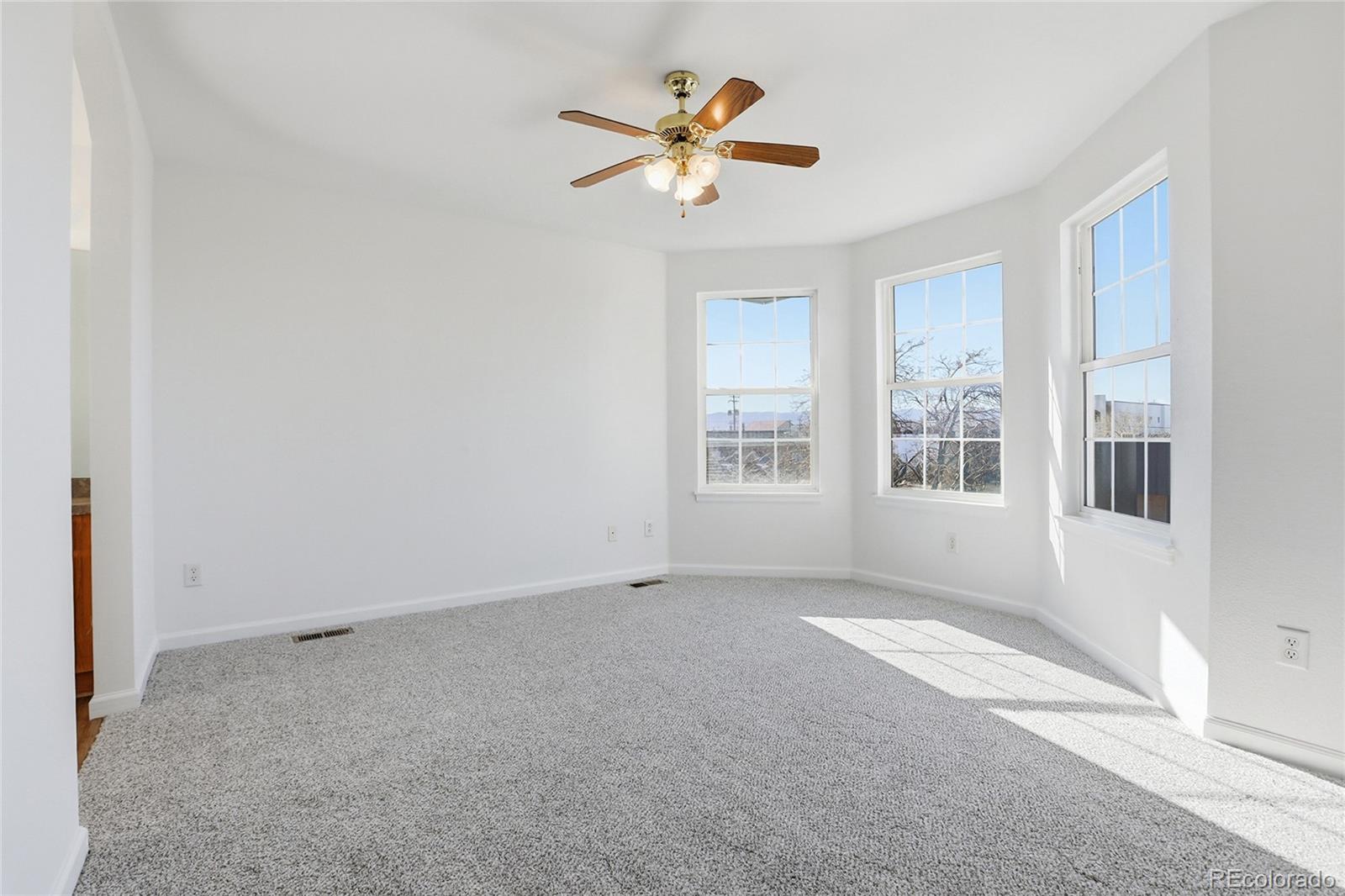 3736 South Inca Street Englewood, CO 80110 - Photo 15 of 31 an empty room with window and a ceiling fan