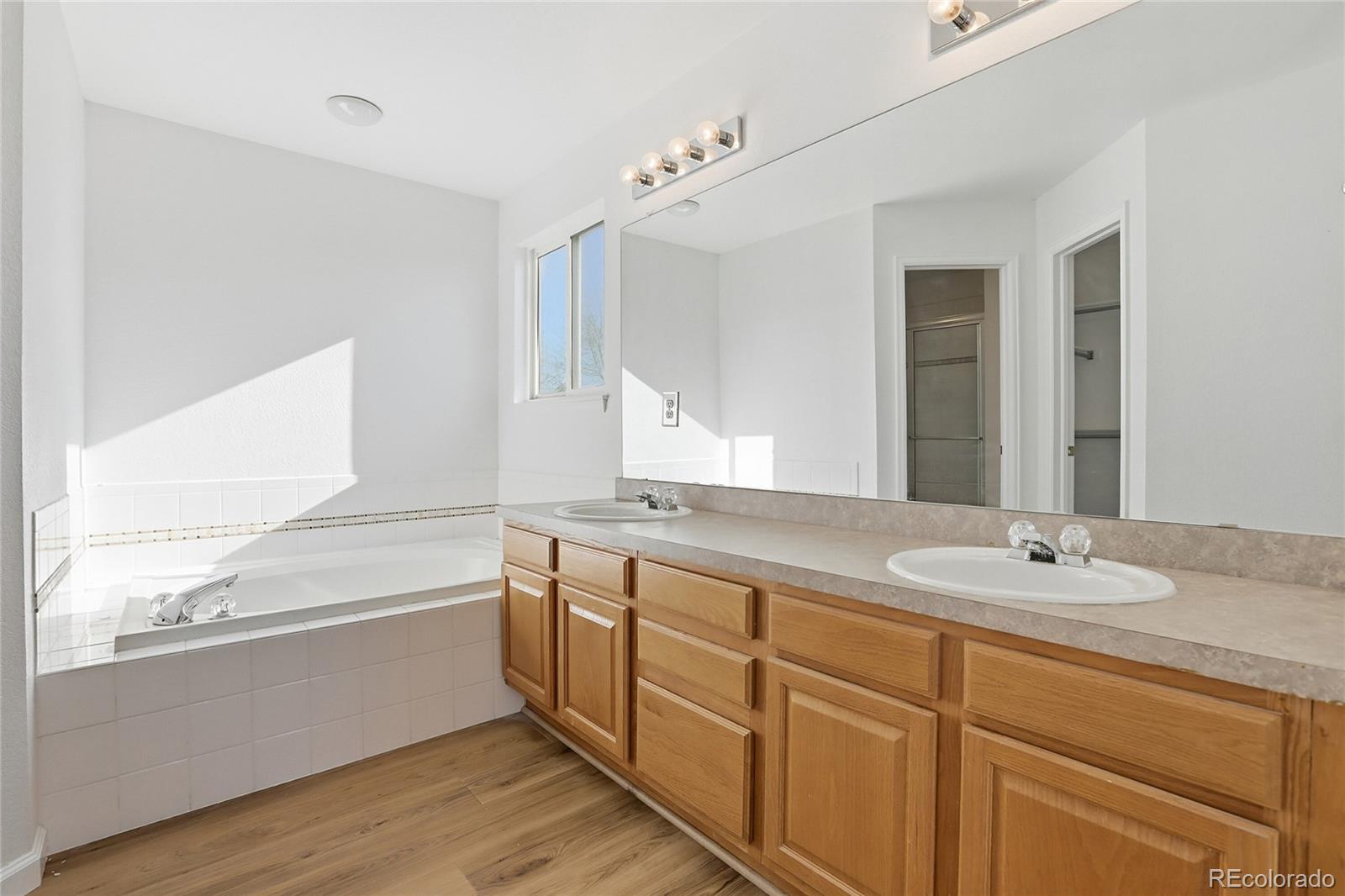 3736 South Inca Street Englewood, CO 80110 - Photo 16 of 31 a bathroom with a granite countertop sink mirror and double