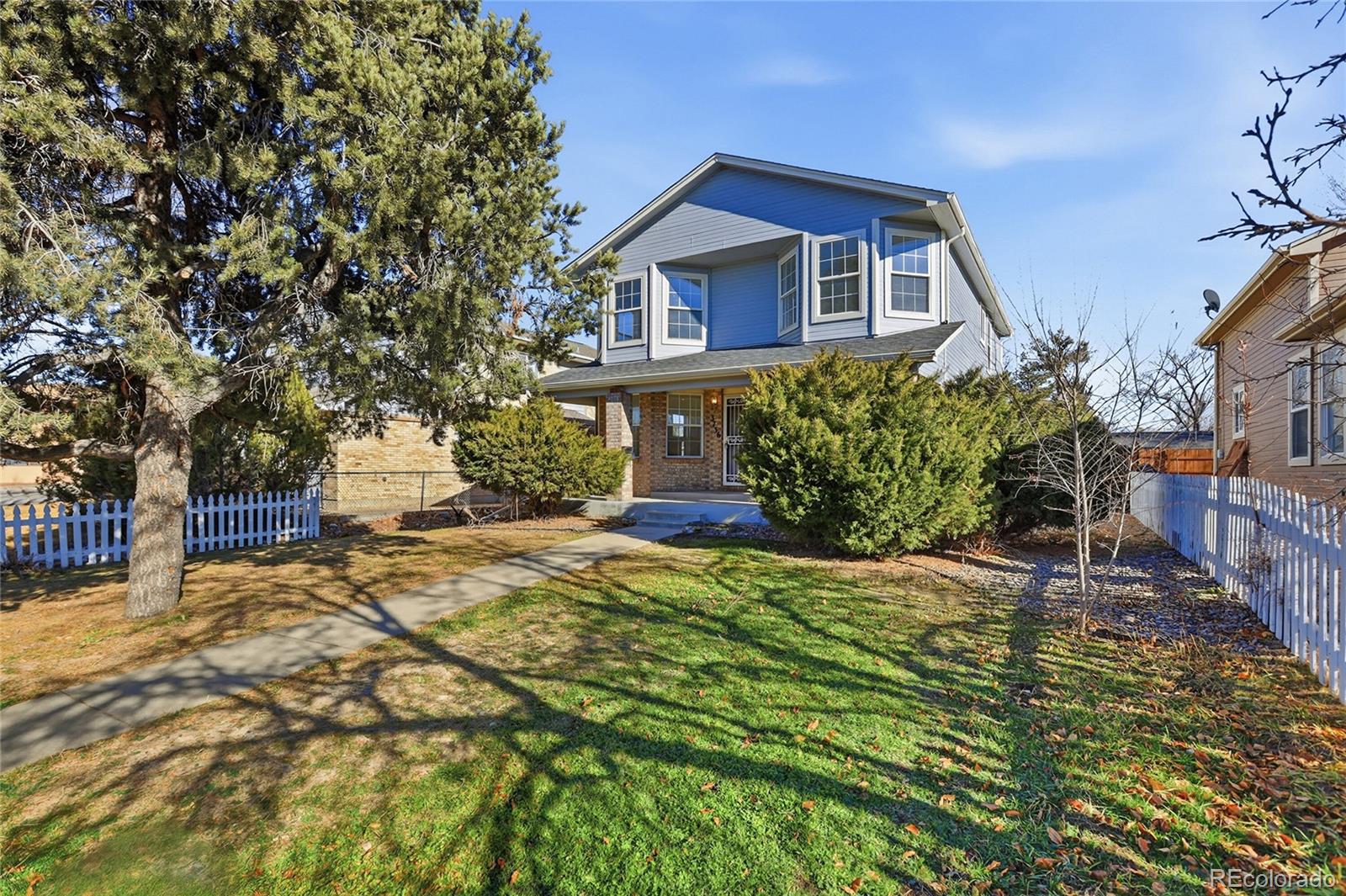 3736 South Inca Street Englewood, CO 80110 - Photo 31 of 31 a front view of a house with a yard