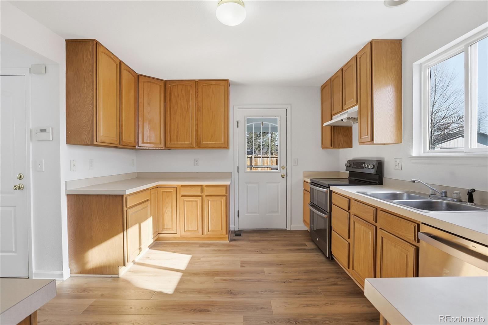 3736 South Inca Street Englewood, CO 80110 - Photo 9 of 31 a kitchen with a sink cabinets and window