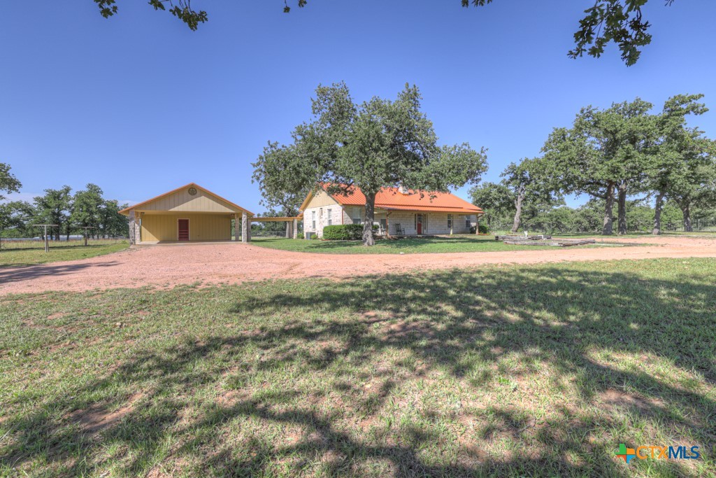 82 Bell Mountain Road Willow City, TX 78675 - Photo 4 of 41 a house with garden in front of it