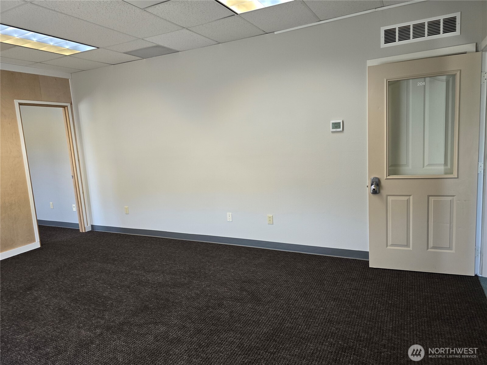 502 South Still Road, Unit 201 Sequim, WA 98382 - Photo 6 of 13 an empty room with a door