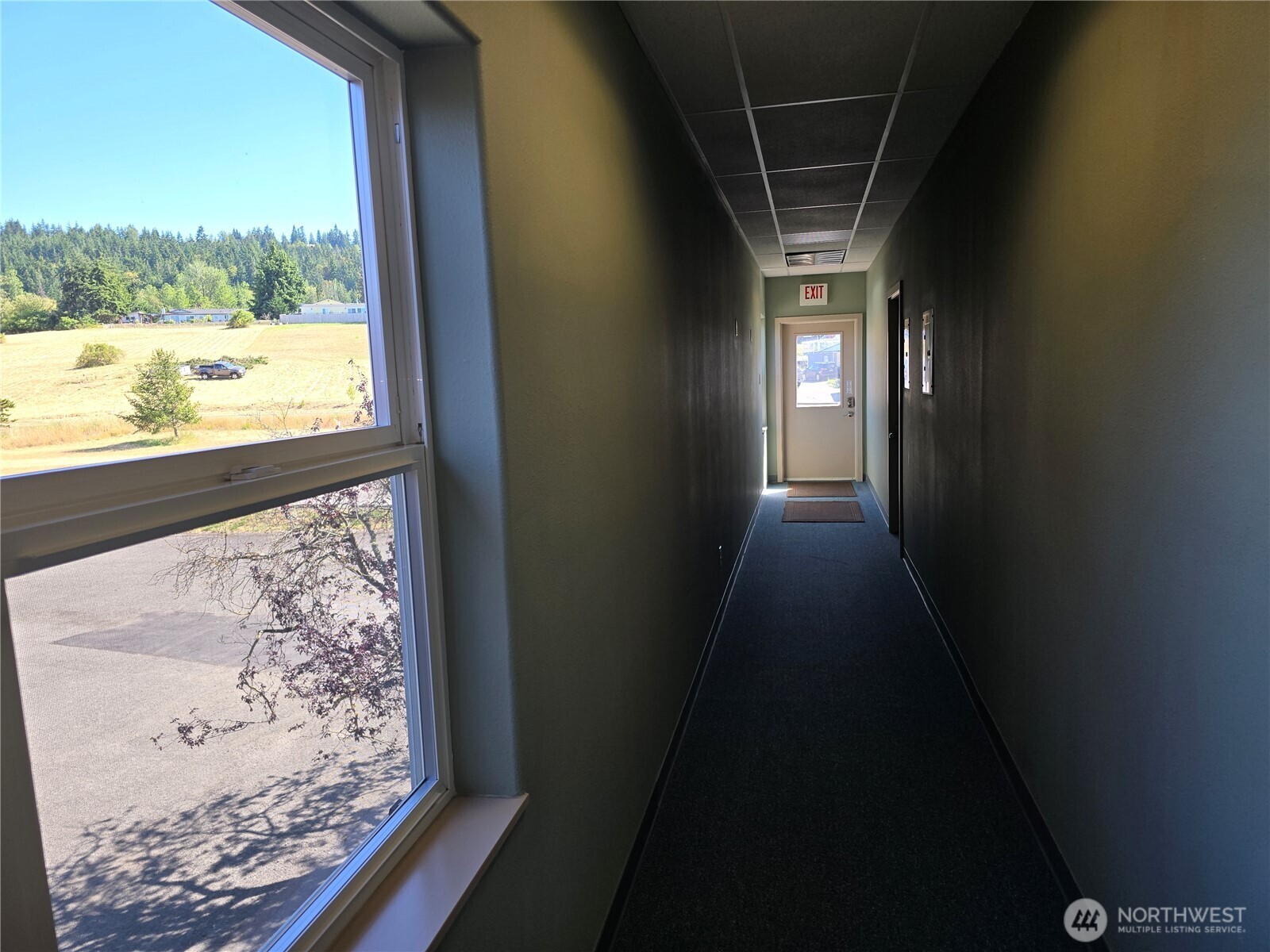 502 South Still Road, Unit 201 Sequim, WA 98382 - Photo 10 of 13 a view of hallway with wooden floor and a floor to ceiling window