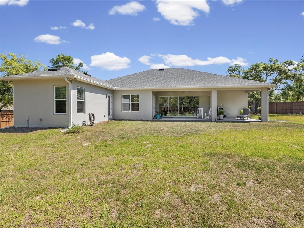 11981 Robina Road Weeki Wachee, FL 34614 - Photo 52 of 93 a front view of house with yard and trees in the background