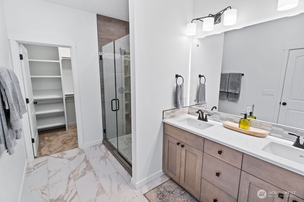 231 Shrute Road Prosser, WA 99350 - Photo 15 of 36 a spacious bathroom with a granite countertop sink a mirror a vanity and a shower