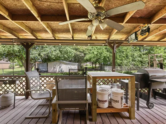 a view of a patio with table and chairs