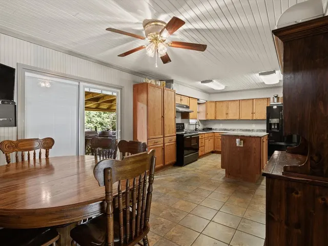 a view of a dining room with furniture and a kitchen