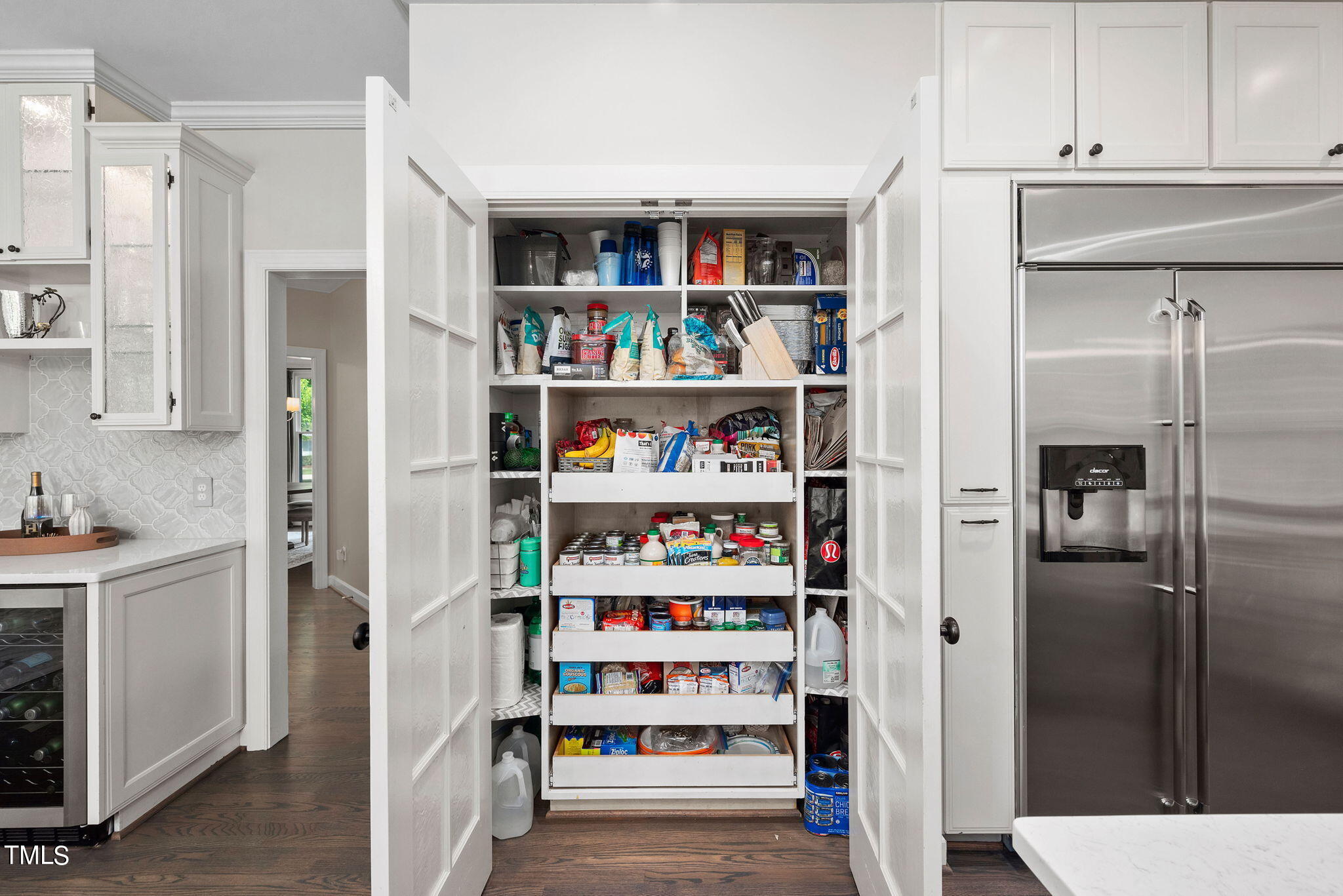 300 Pond Bluff Way Cary, NC 27513 - Photo 14 of 73 a living room with stainless steel appliances cabinets and a book shelf