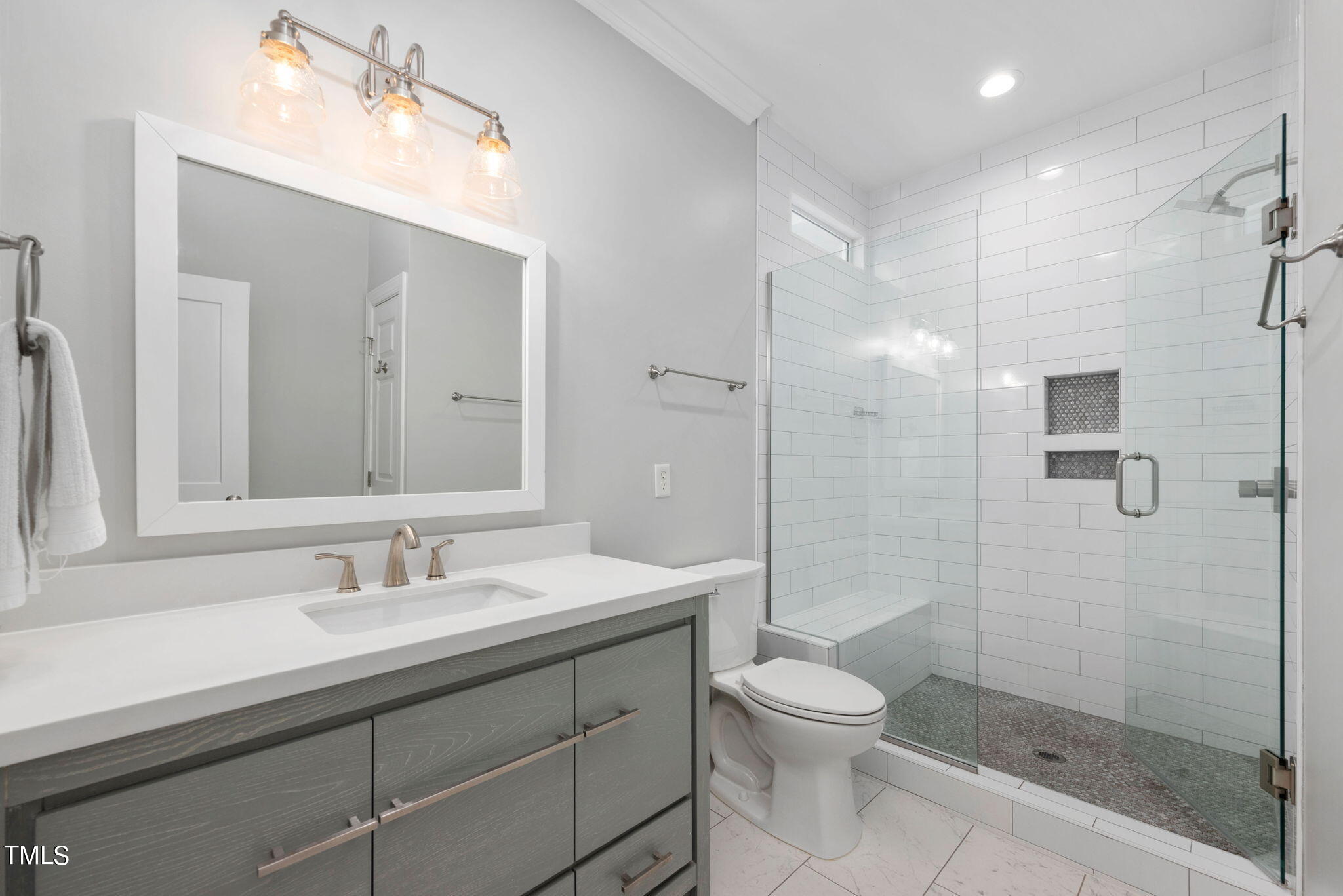 300 Pond Bluff Way Cary, NC 27513 - Photo 18 of 73 a bathroom with a shower sink mirror and toilet