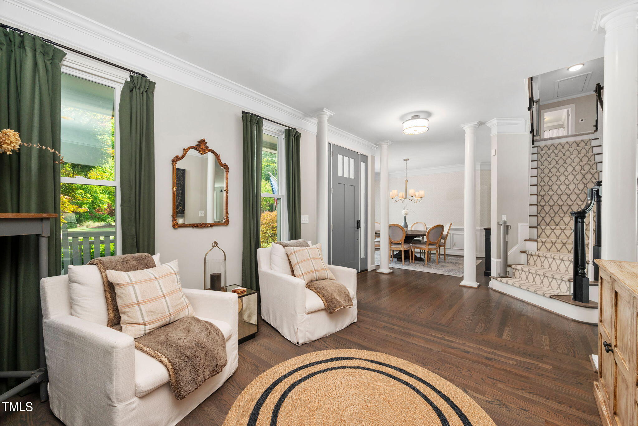 300 Pond Bluff Way Cary, NC 27513 - Photo 3 of 73 a living room with furniture a fireplace and a floor to ceiling window