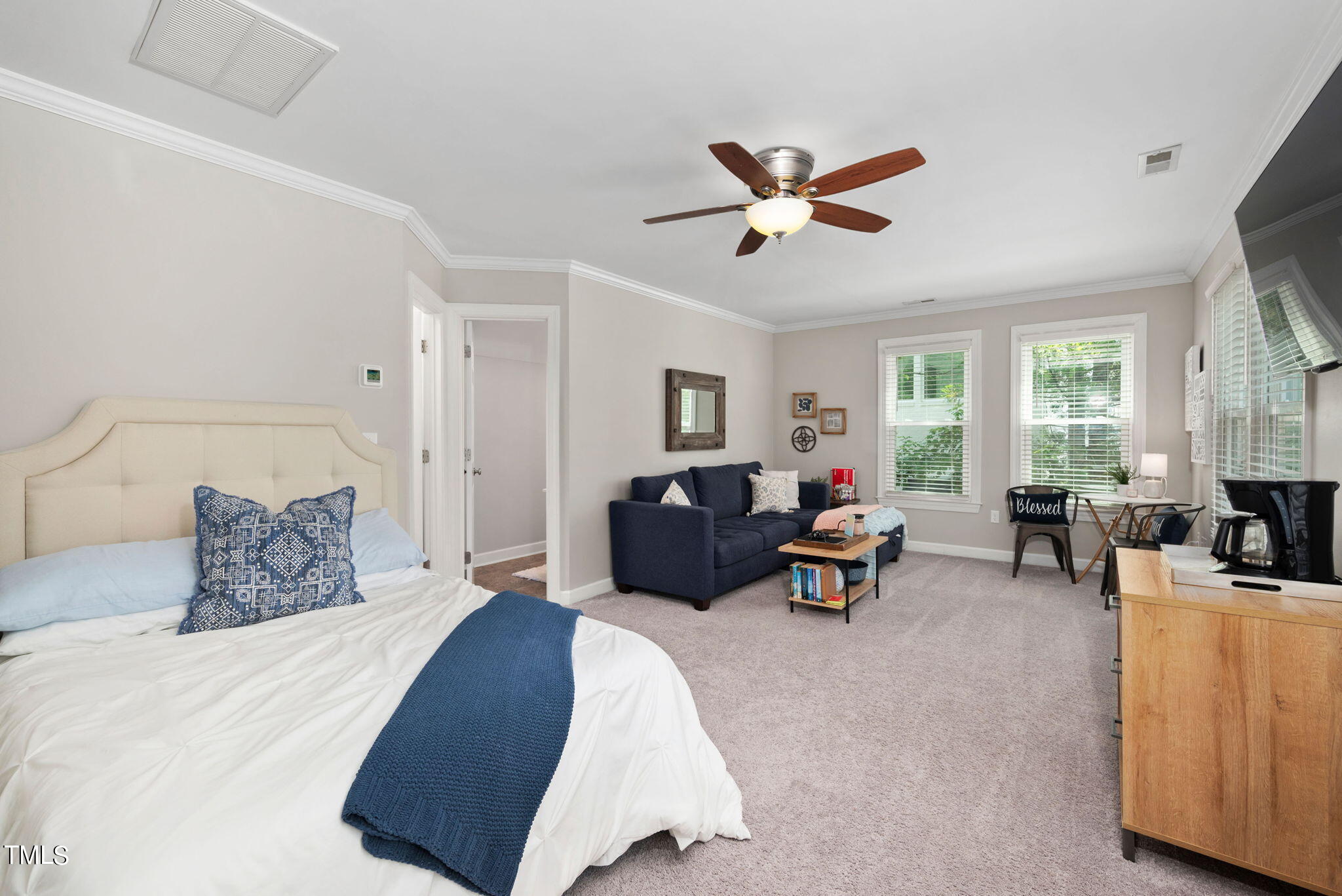 300 Pond Bluff Way Cary, NC 27513 - Photo 40 of 73 a bedroom with a bed a couch and dresser with wooden floor