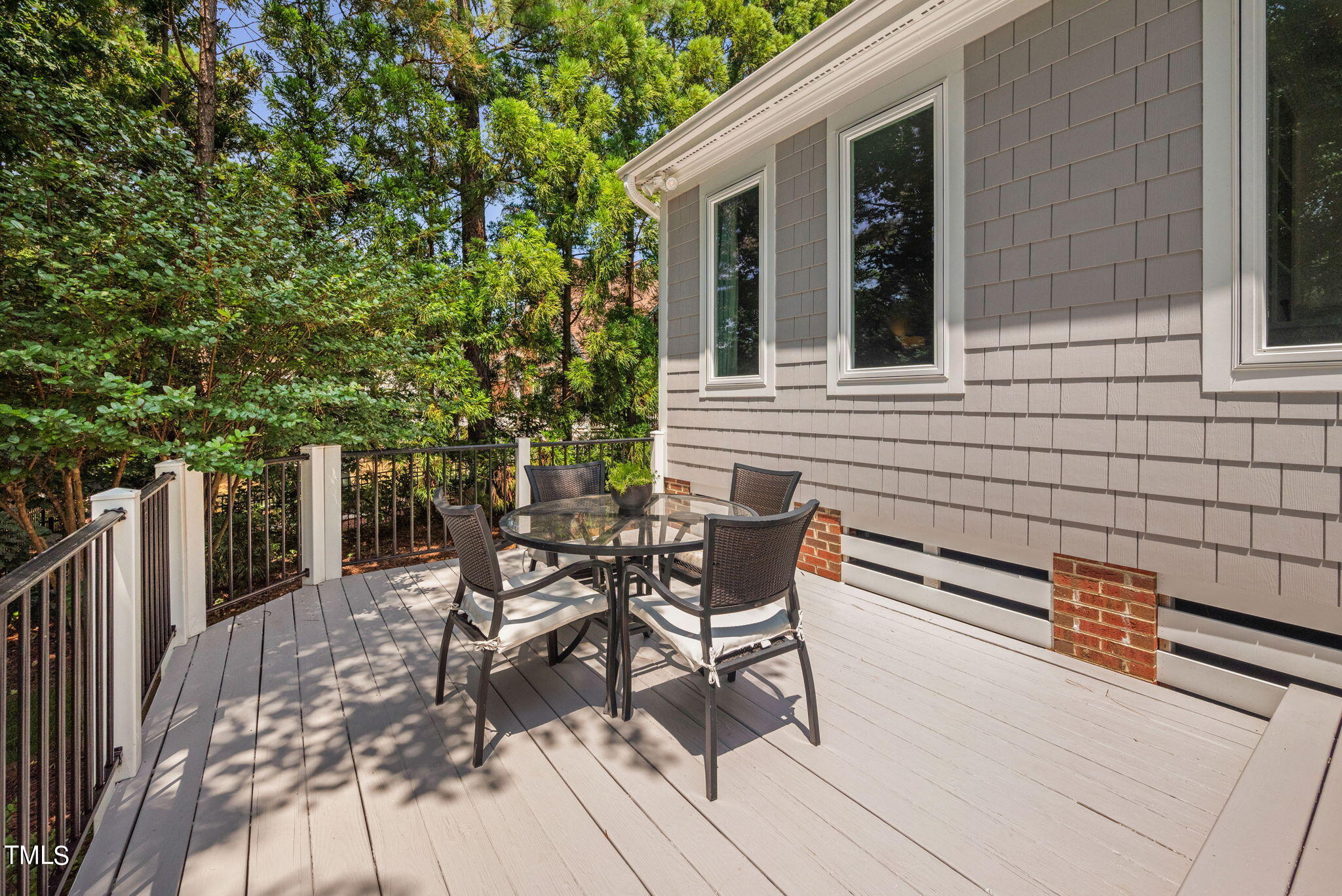 300 Pond Bluff Way Cary, NC 27513 - Photo 47 of 73 a view of a patio with table and chairs and wooden fence