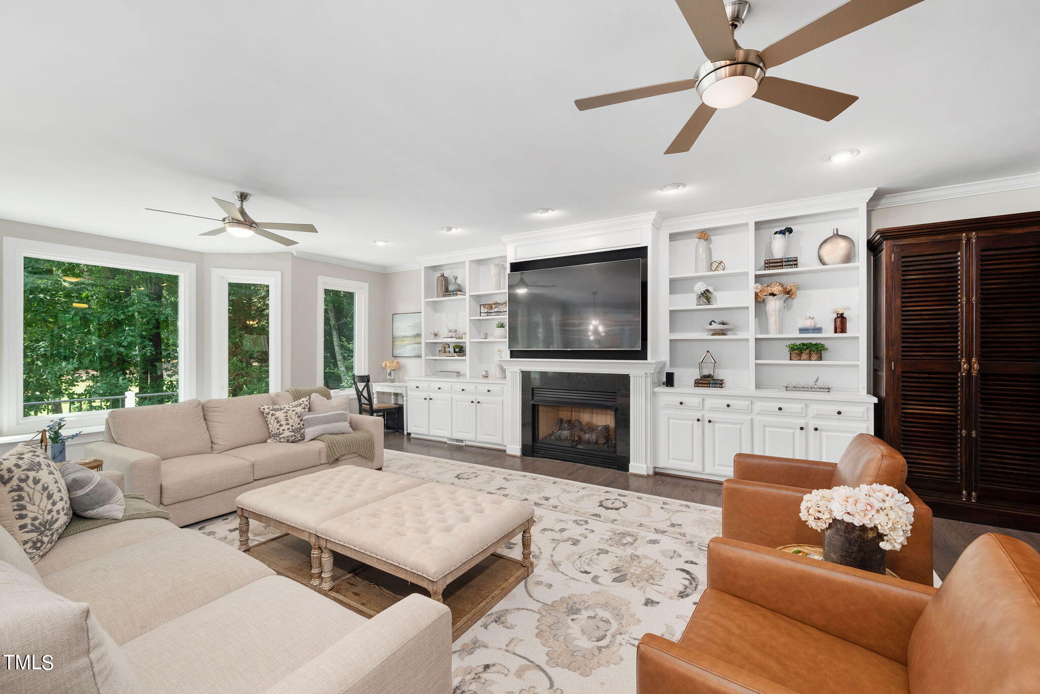 300 Pond Bluff Way Cary, NC 27513 - Photo 8 of 73 a living room with furniture a fireplace and a flat screen tv