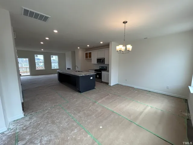 a view of a kitchen with a sink and a chandelier
