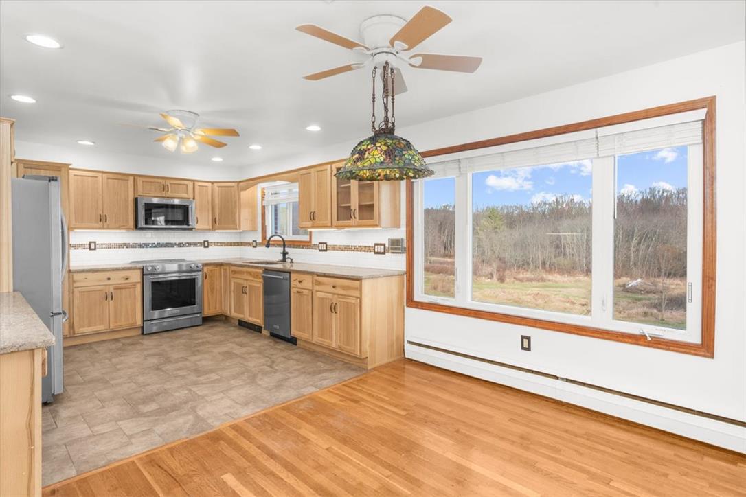 988 Hoch Road Danielsville, PA 18038 - Photo 12 of 29 A well-lit kitchen with natural wood cabinetry offers scenic outdoor views.