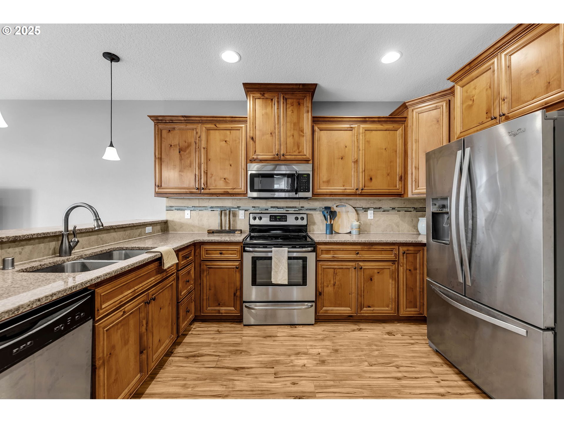 217 North 33rd Court Ridgefield, WA 98642 - Photo 11 of 35 a kitchen with stainless steel appliances granite countertop a stove a sink and a refrigerator