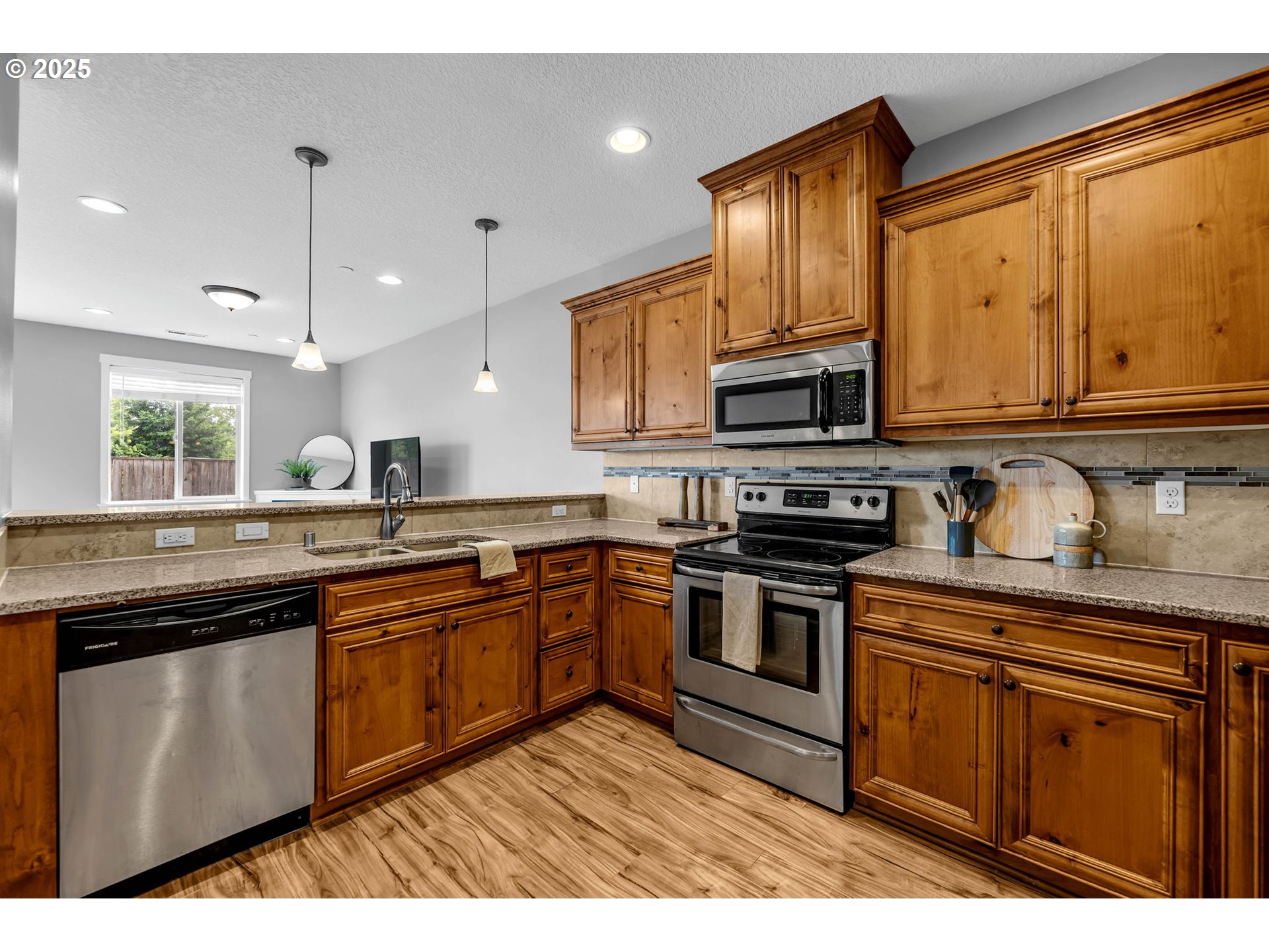 217 North 33rd Court Ridgefield, WA 98642 - Photo 12 of 35 a kitchen with stainless steel appliances granite countertop a stove sink and cabinets