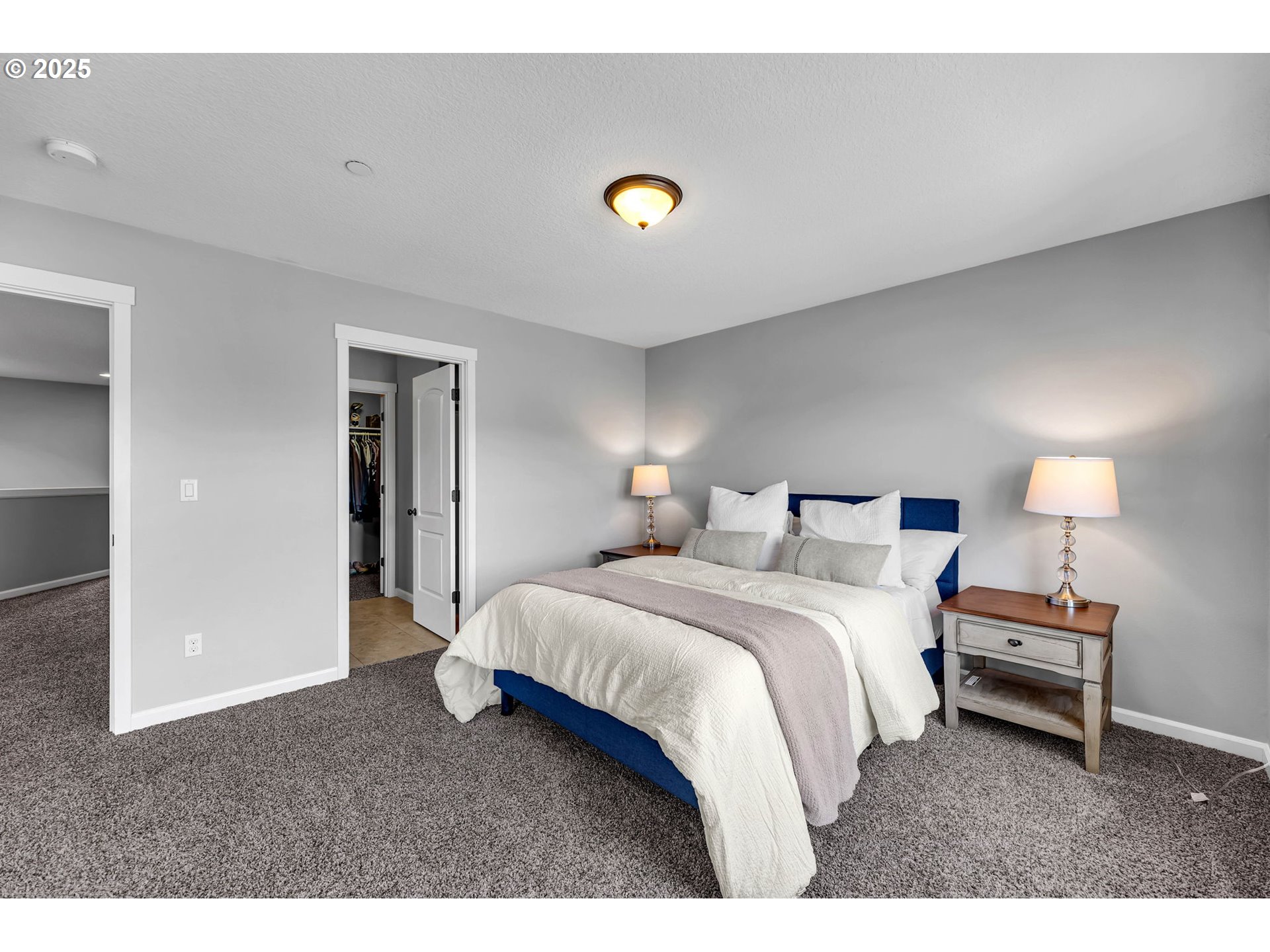217 North 33rd Court Ridgefield, WA 98642 - Photo 23 of 35 a bedroom with a bed and a night stand