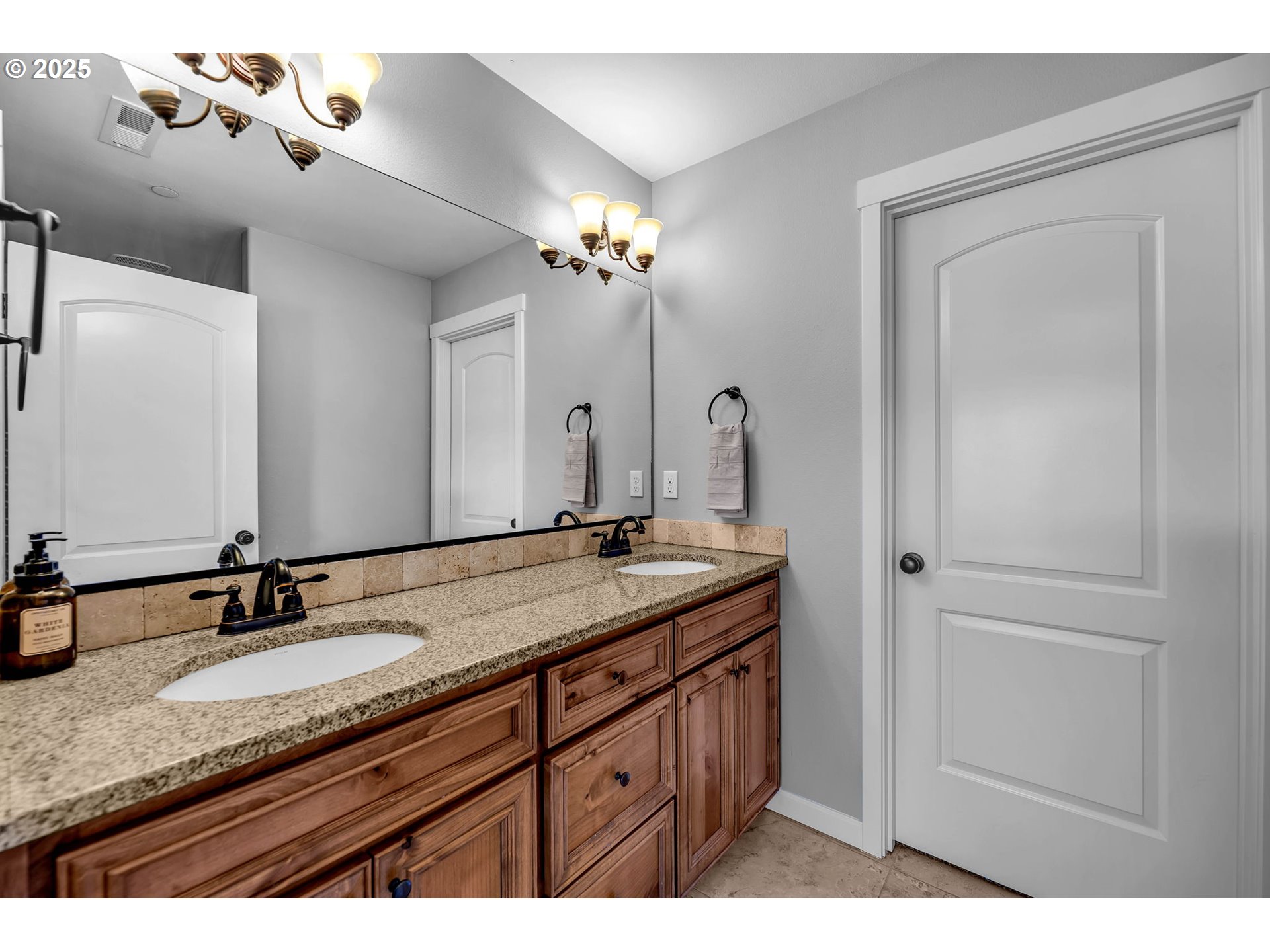 217 North 33rd Court Ridgefield, WA 98642 - Photo 28 of 35 a bathroom with a granite countertop sink double and mirror