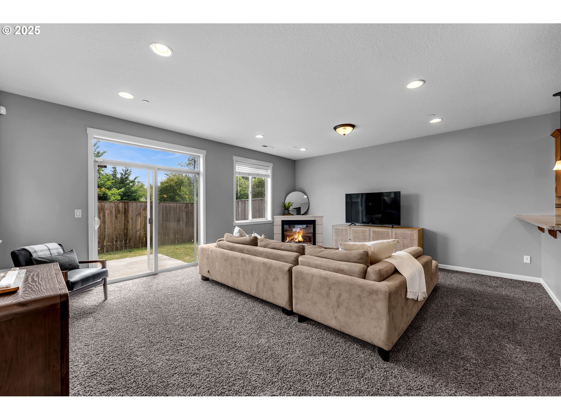 217 North 33rd Court Ridgefield, WA 98642 - Photo 6 of 35 a living room with furniture and a flat screen tv