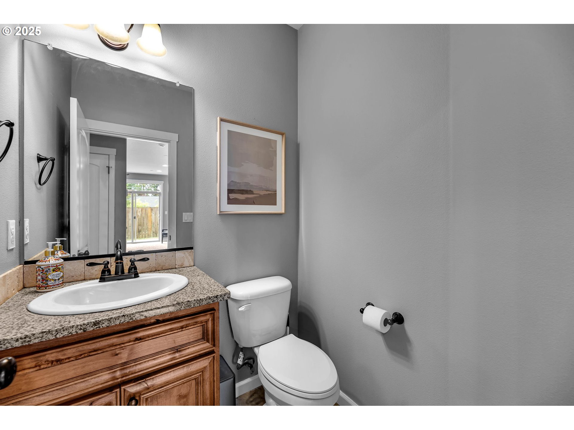 217 North 33rd Court Ridgefield, WA 98642 - Photo 10 of 35 a bathroom with a sink toilet a mirror and vanity